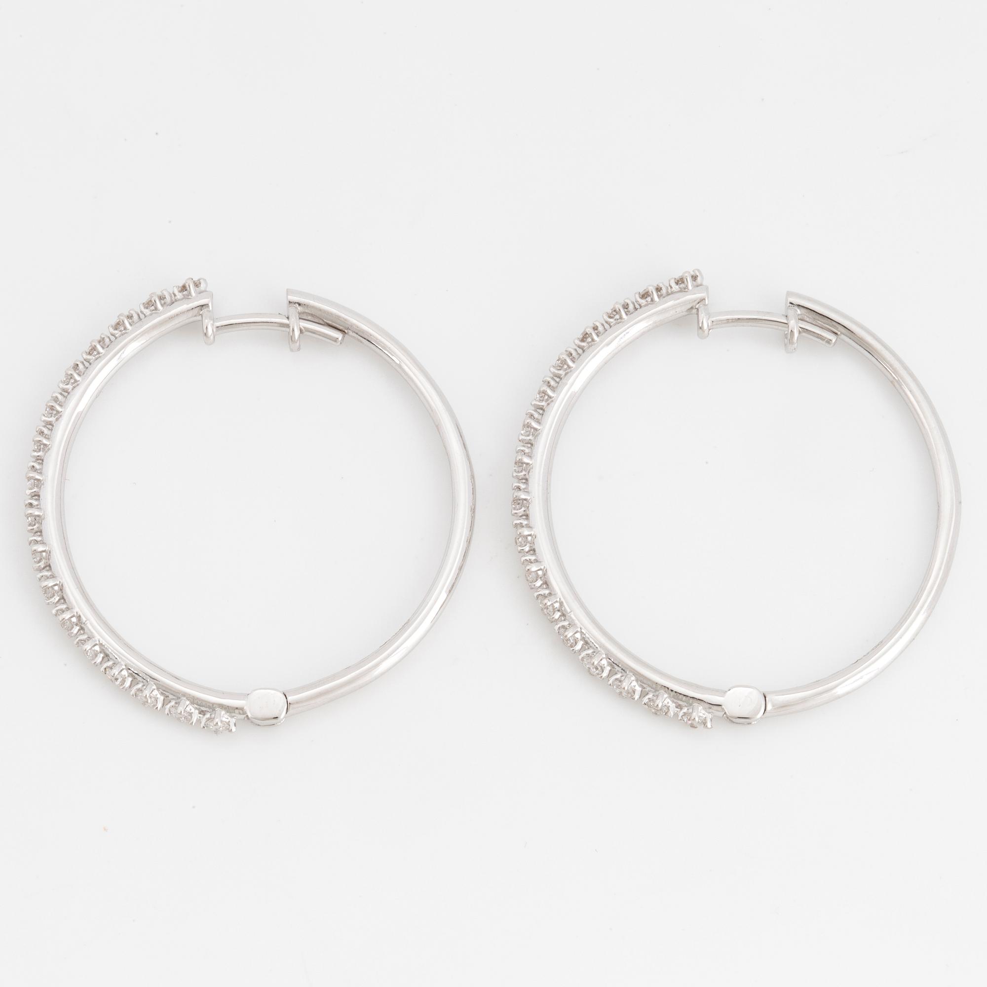 Brilliant-cut diamond hoop earrings.