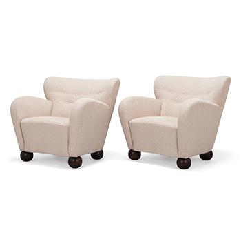 A pair of mid-20th-centuy armchairs.