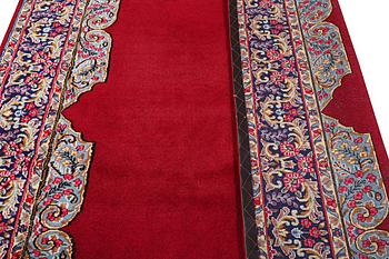 An old Kerman carpet, signed, c. 290 x 208 cm.