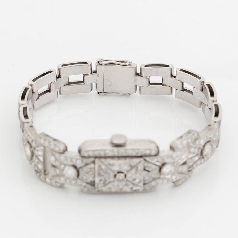 A bracelet/watch in platinum and 18K white gold set with old- and eight-cut diamonds.