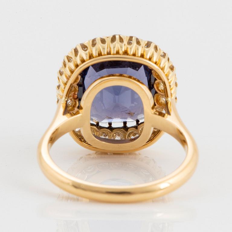 An 18K gold ring set with a cushion-cut purple spinel 6.15 cts according to information given.