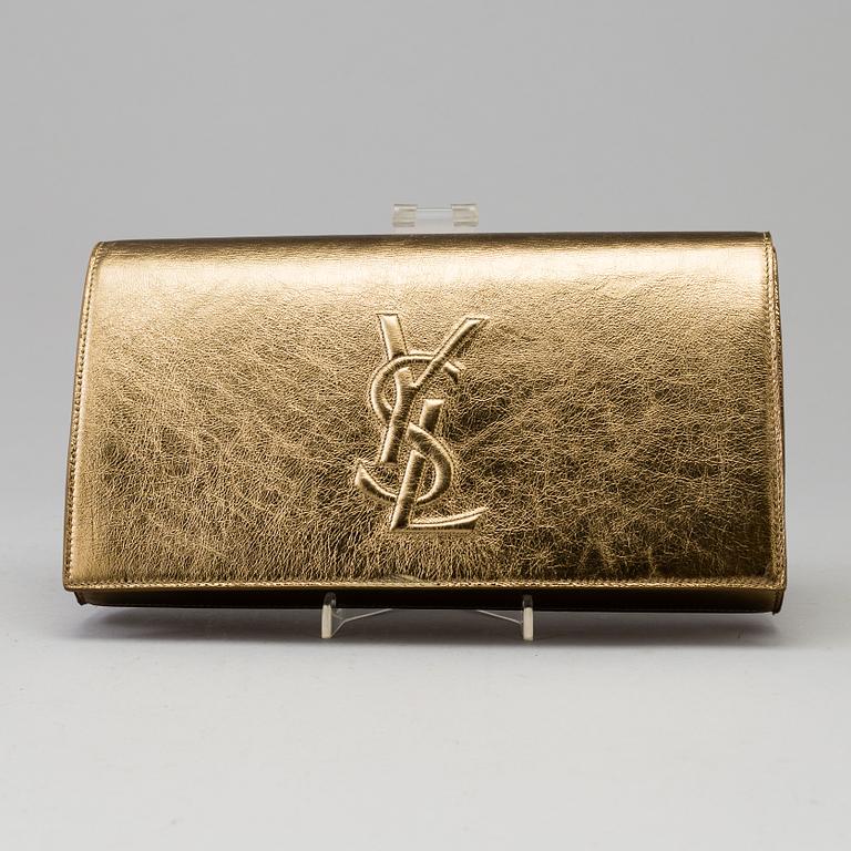 YVES SAINT LAURENT, a gold leather clutch.