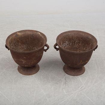 A pair of early 20th century iron garden urns.