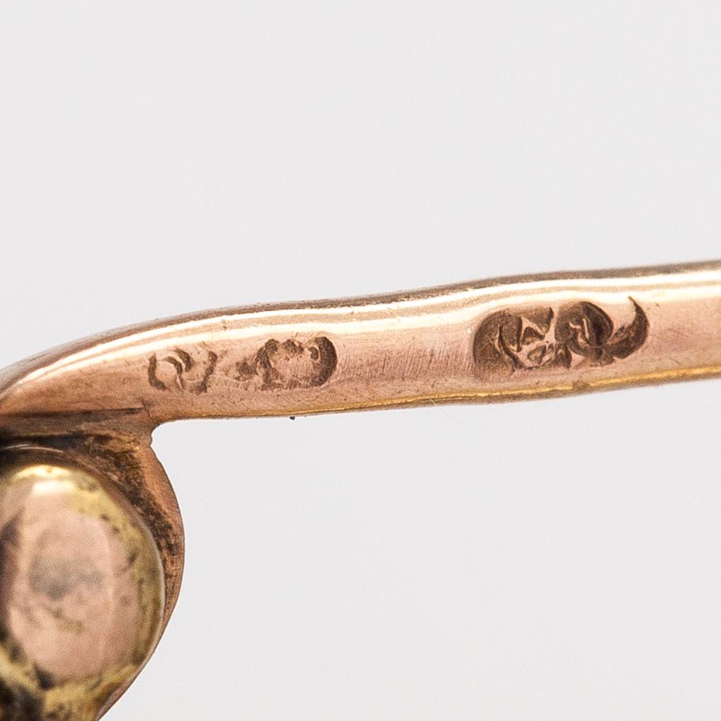 Brosch, 18K och 14K guld, turkos ca 0.95 ct och gammaslipade diamanter ca 0.95 ct tot.