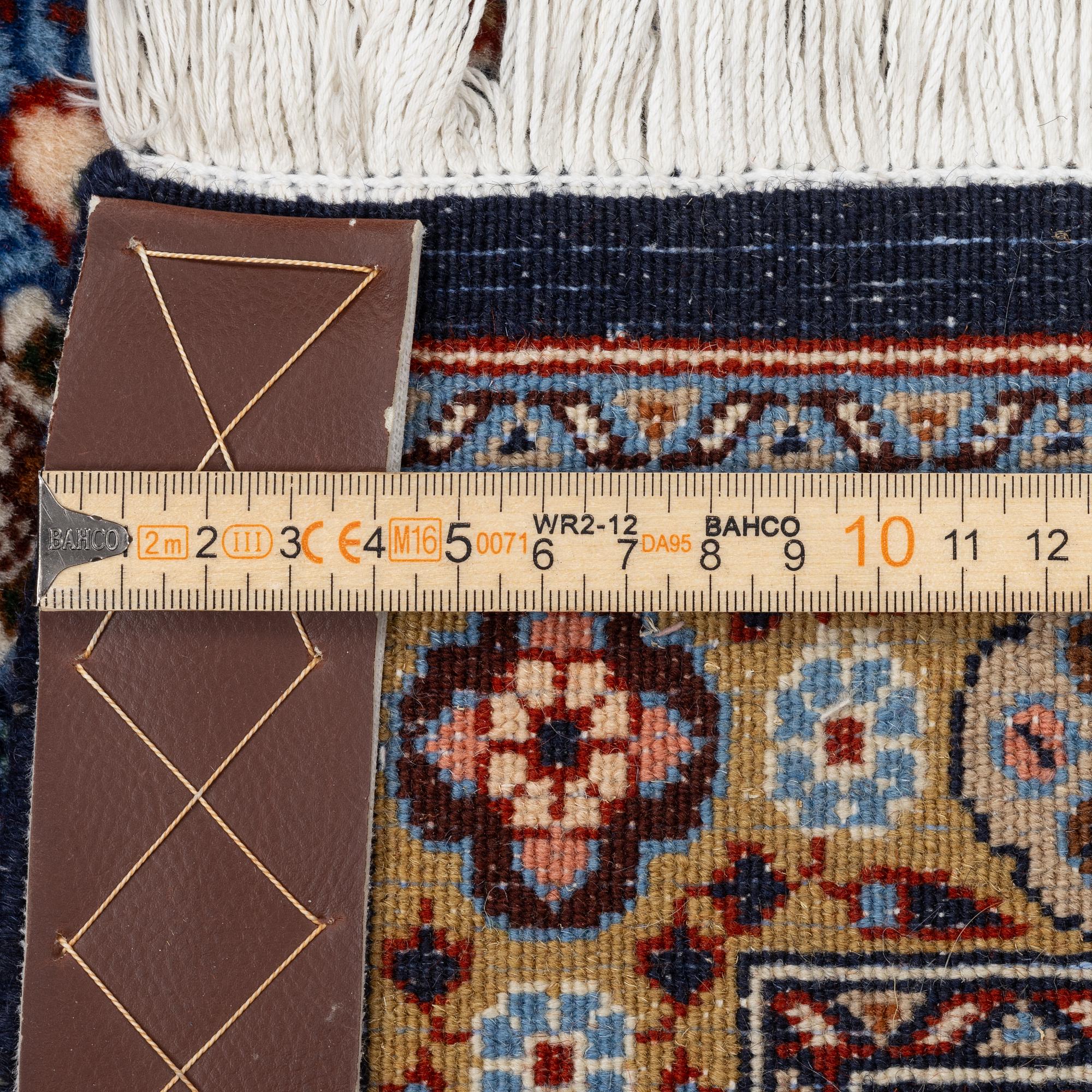 A Moud carpet, part silk, signed, c. 345 x 249 cm.