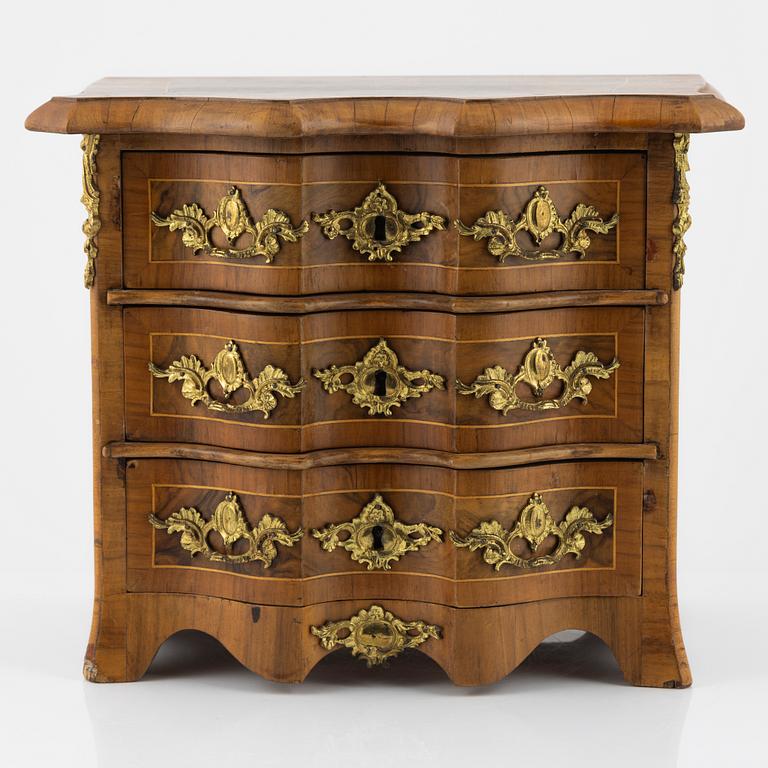 A late Baroque walnut-veneered miniature commode, 20th century.