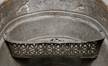 A Baroque brass wine cooler.