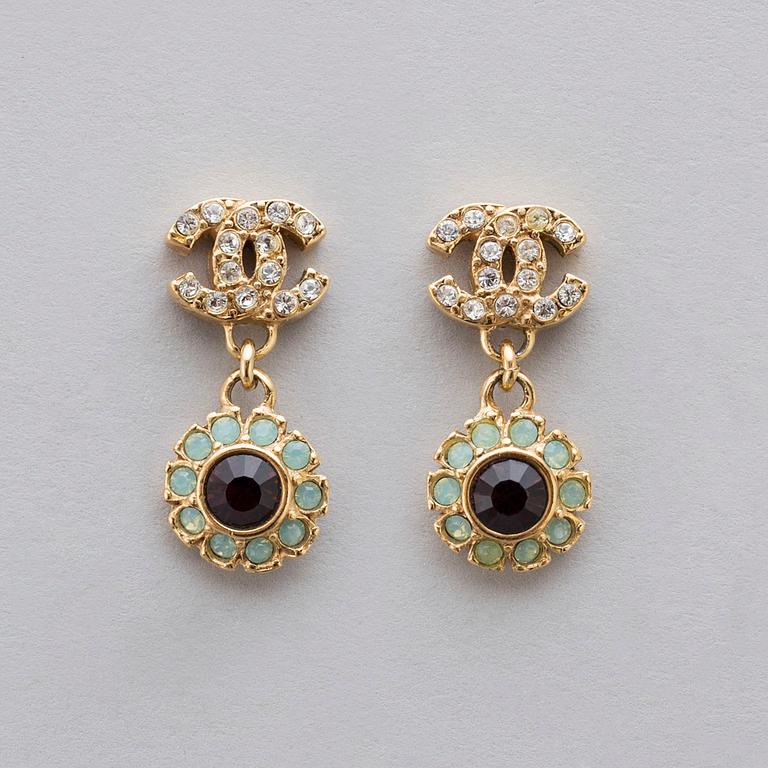 Apair of Chanel golden earrings with white and red stones, 2006.