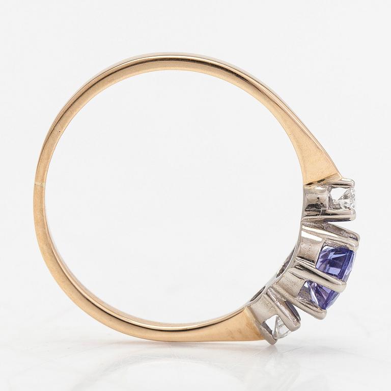 An 18K white gold ring, with a tanzanite and diamonds totalling approximately 0.04 ct.