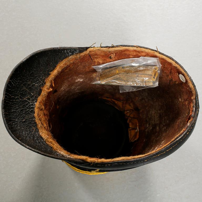 Five military helmets and a hat, late 19th and 20th century.