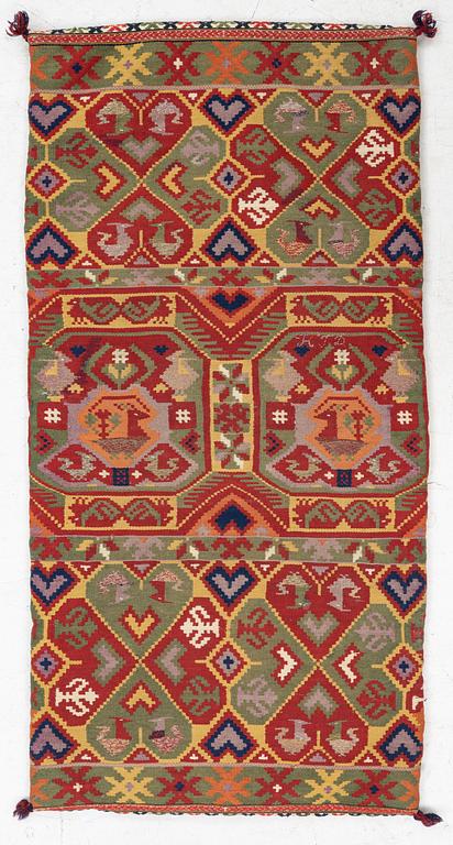 A double-interlocked tapestry carrige cushion, c 100 x 50 cm, Scania, mid 19th century.