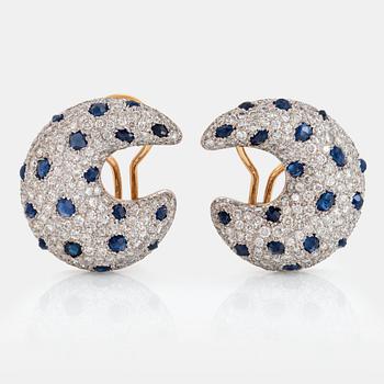 1055. A pair of 18K gold earrings set with round brilliant-cut diamonds and faceted sapphires.