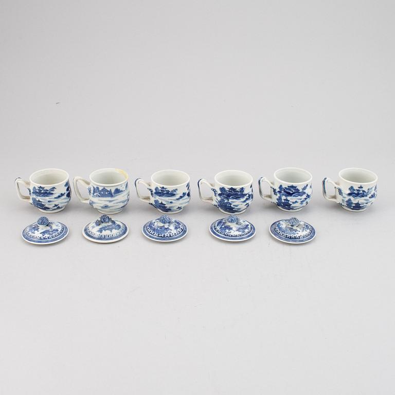 A set of six blue and white custard cups with covers,