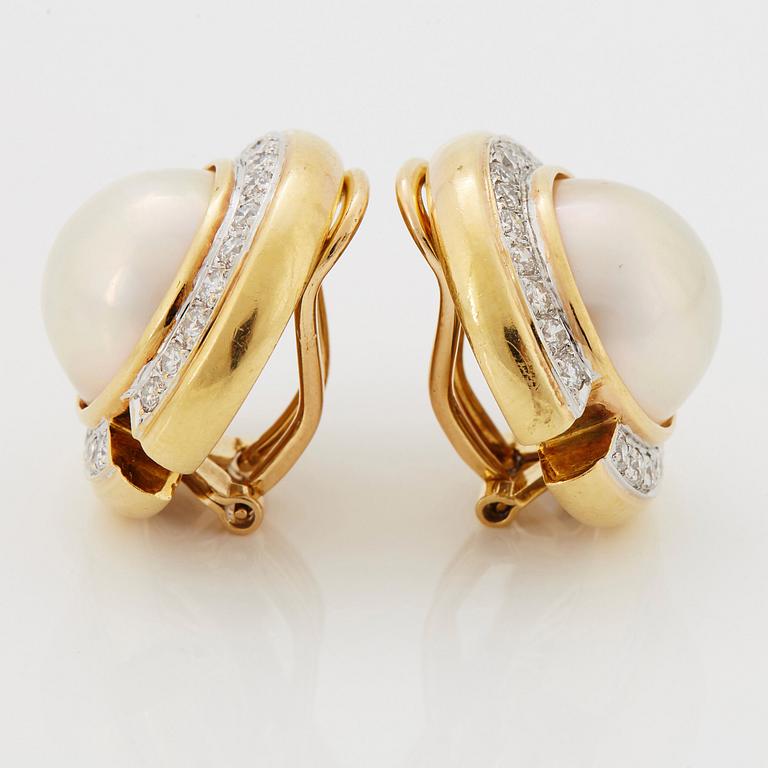 A pair of 18K gold and mabe pearl earrings set with round brilliant-cut diamonds.