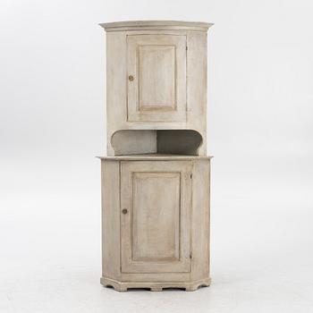 A corner cabinet, 19th Century.