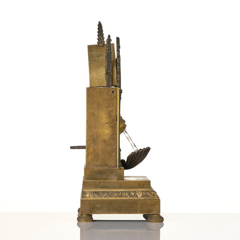 An English neo-Gothic patinated and ormolu mechanical mantel clock, ca 1820.