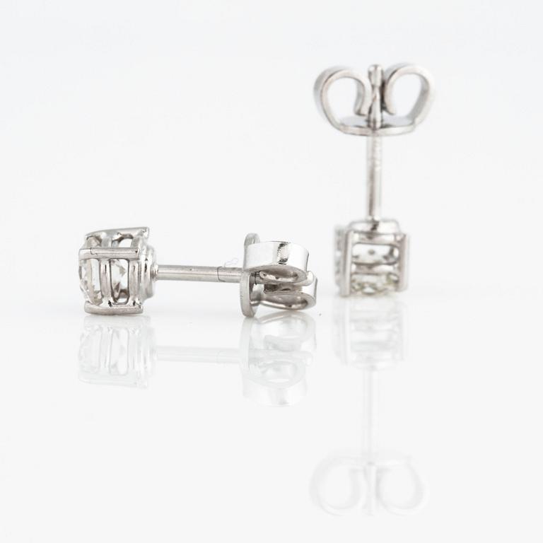 A pair of brilliant cut diamond earrings.