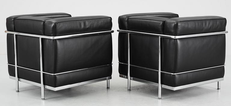 A pair of Le Corbusier 'LC 2' black leather and chromed steel easy chairs, by Cassina, Italy.