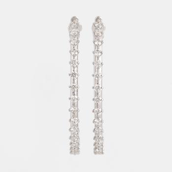 Brilliant-cut diamond hoop earrings.