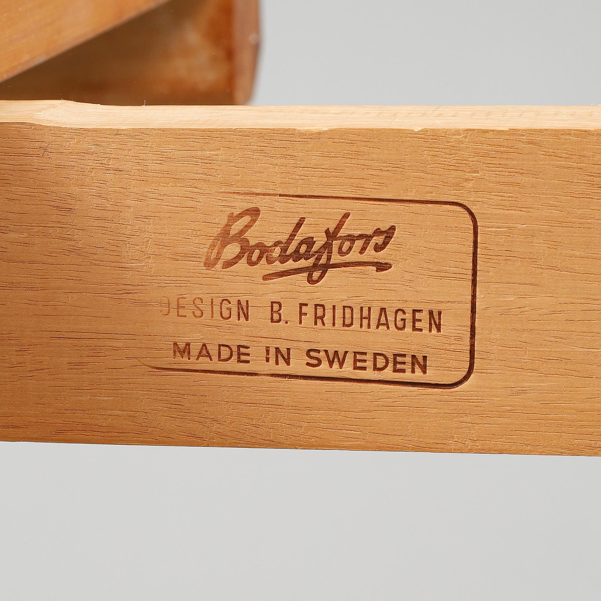 BERTIL FRIDHAGEN, a seven  piece walnut dining suite from Bodafors.