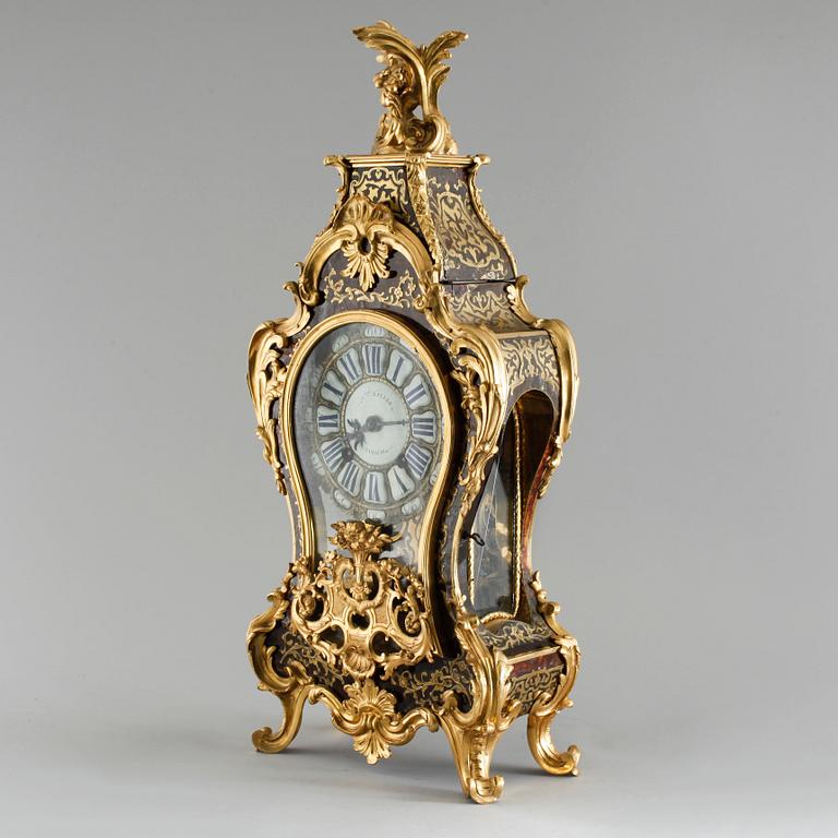 A 19th century mantle clock in the style of Louis XV.