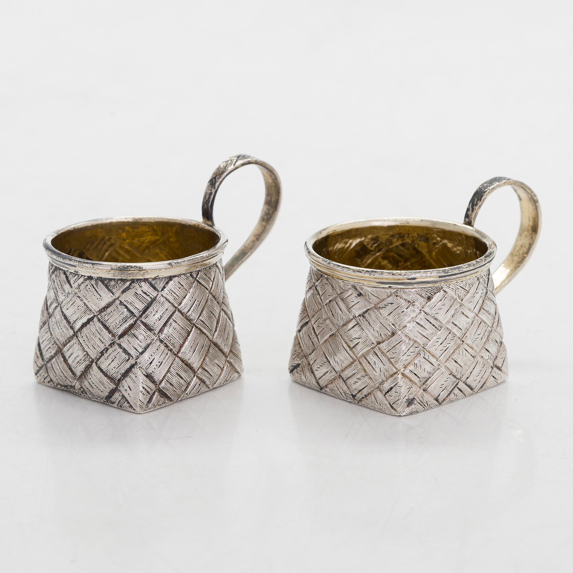 A silver and glass bottle with eight silver charka, maker marks of Pyotr Yermolajevich Davidov, Saint Petersburg, 1884.