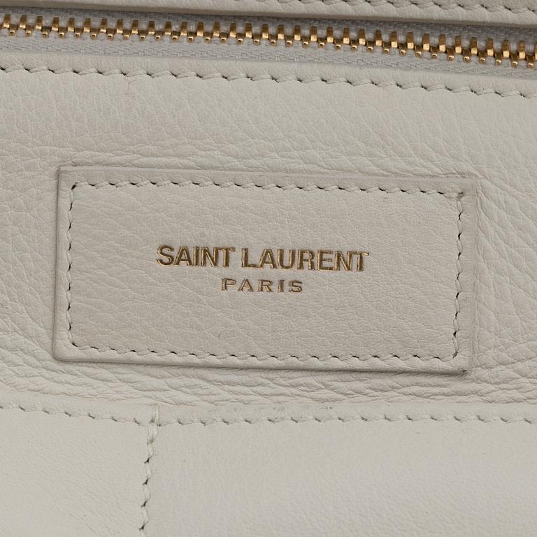 Yves Saint Laurent, a white leather handbag.