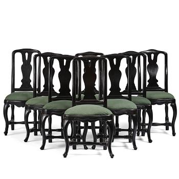 93. A set of eight black Swedish rococo chairs.