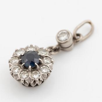 Pendant in 18K gold with a blue stone and diamonds.