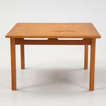 An oak coffee table with a later travertine top.