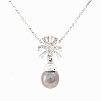An 18K white gold necklace set with a drop-shaped cultured pearl and round brilliant-cut diamonds.
