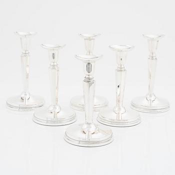 A set of six silver candle sticks, 1960-89.