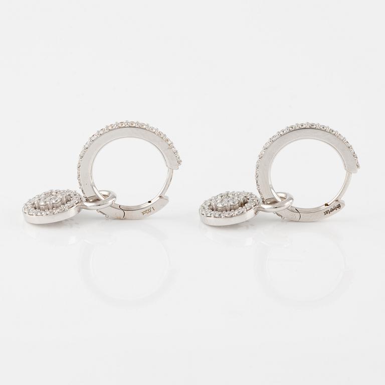 A pair of 18K gold earrings with round brilliant-cut diamonds.