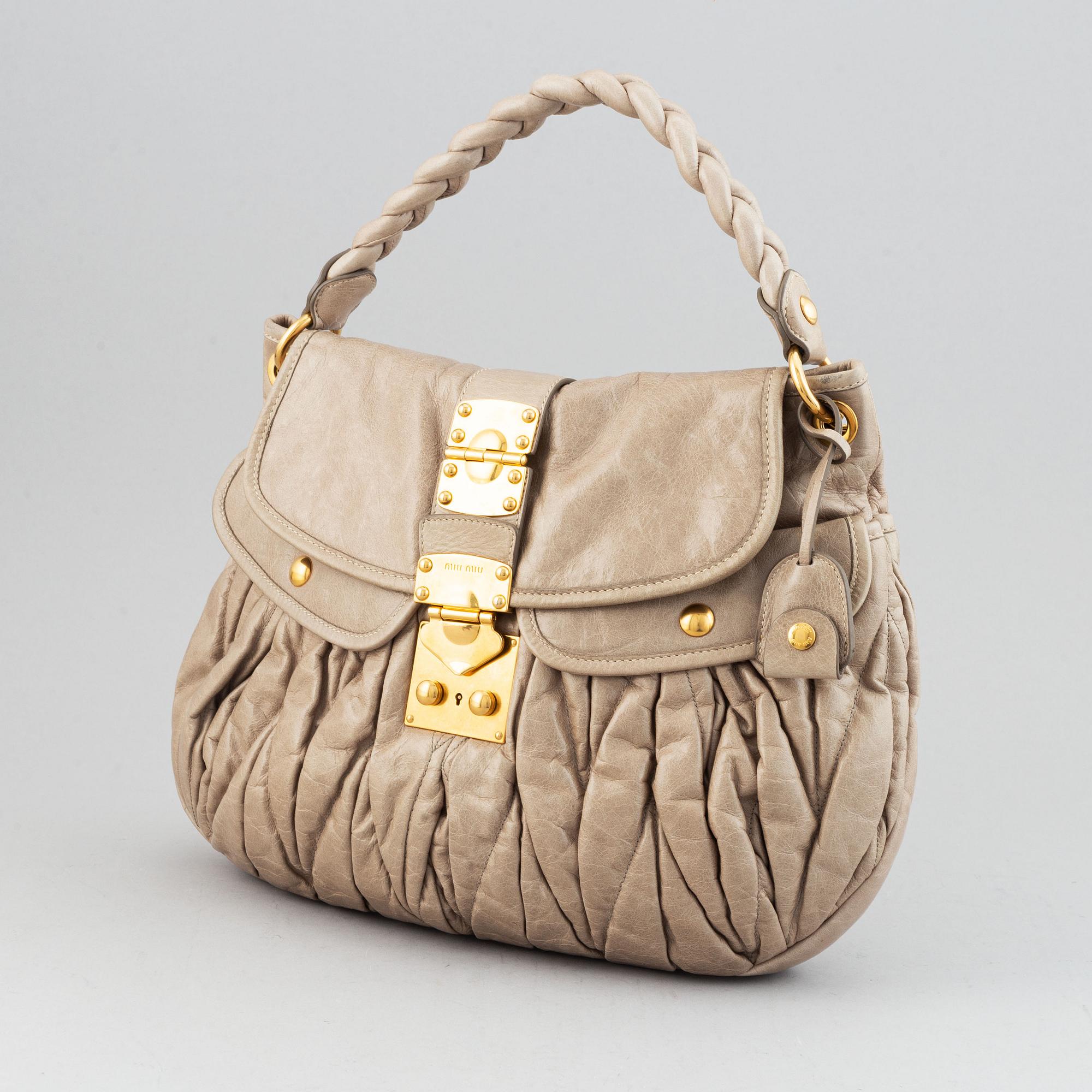 Miu Miu, a light leather handbag.