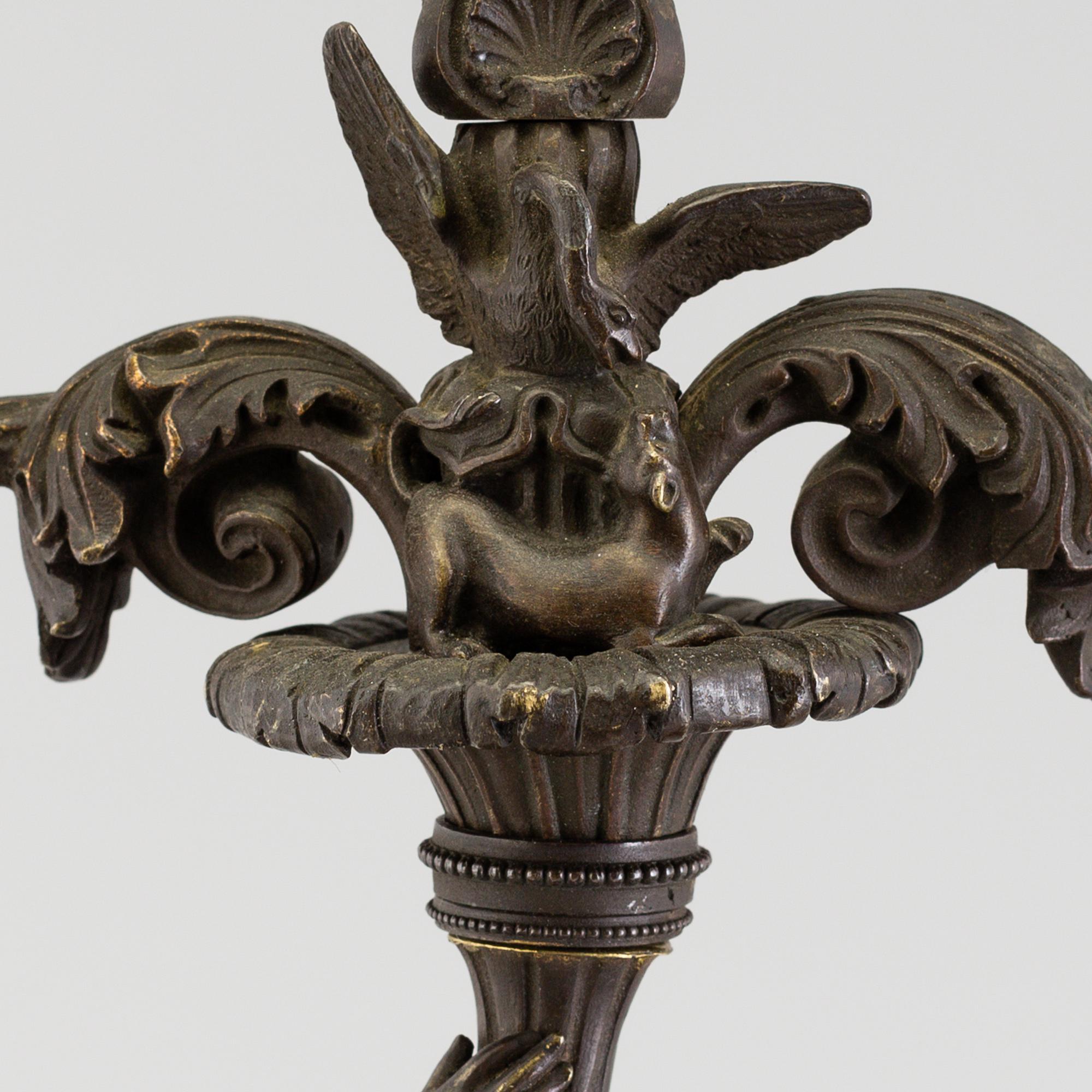 A pair of late 19th century patinated brass candelabra.