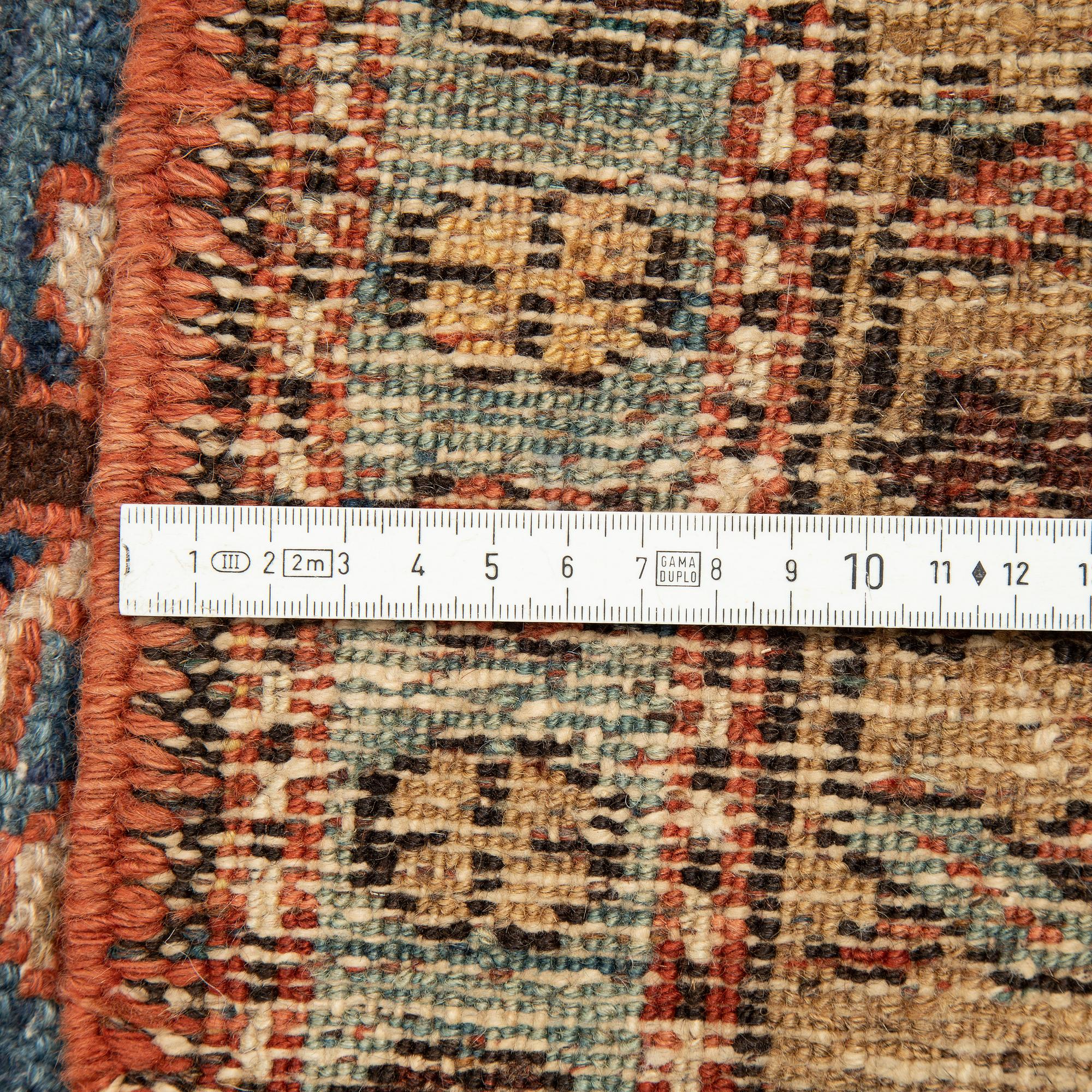 A Heriz runner, ca 310 x 85 cm.