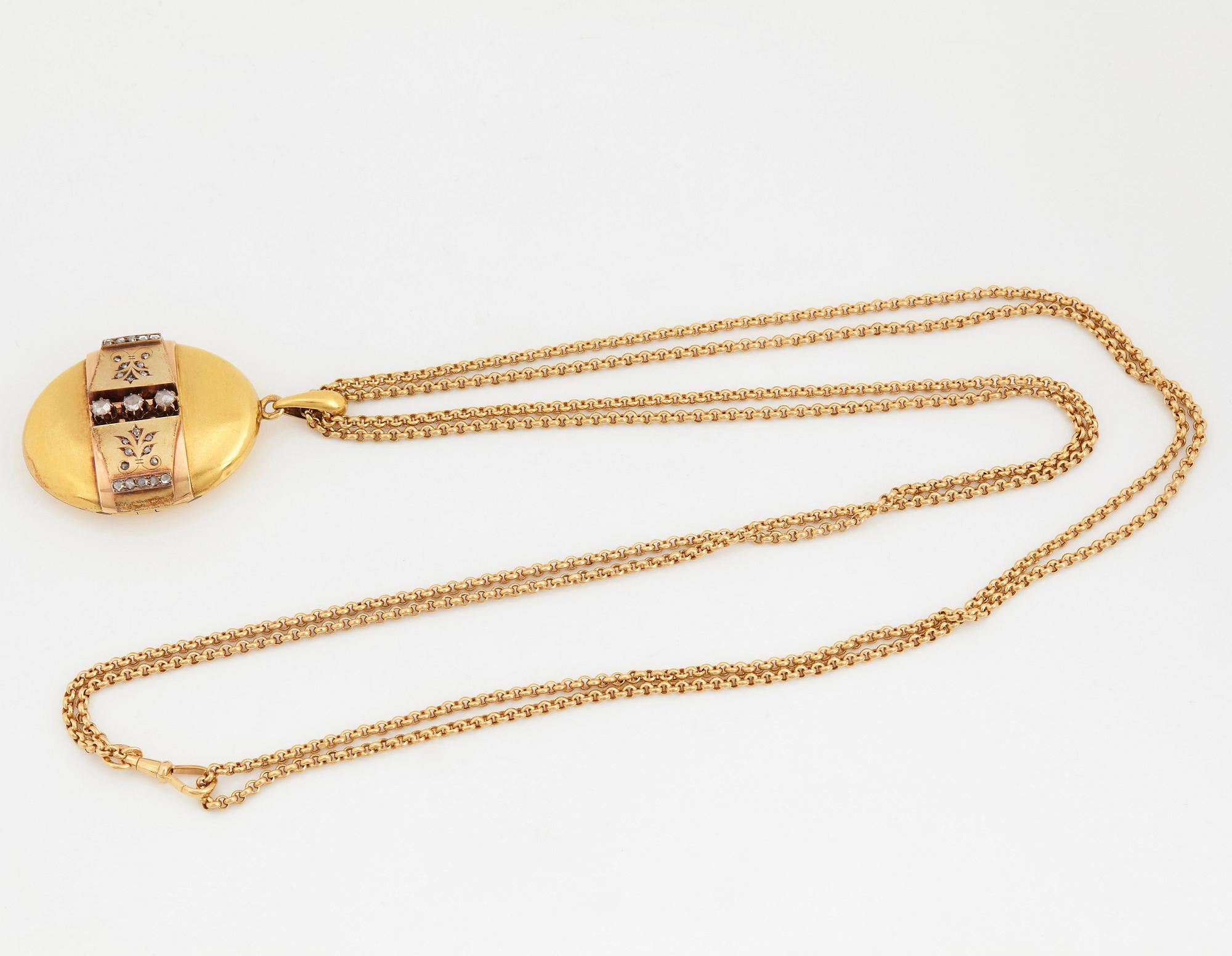 An 18K gold locket set with rose-cut diamonds.