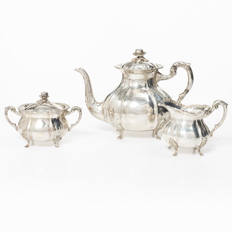 A Rococo style silver coffee pot, cream jug and sugar bowl, 20th century, Swedish import mark.