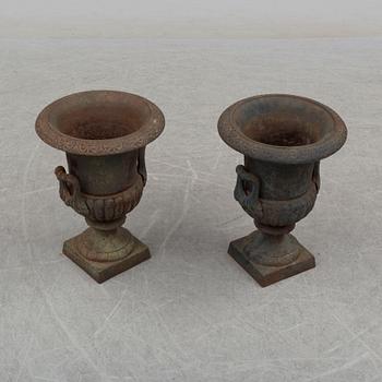 A pair of 20th century iron garden urns.