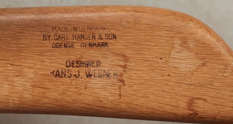 A pair of Hans J Wegner oak and rattan 'CH-27' armchairs, Carl Hansen & Son, Denmark, 1950's-60's.