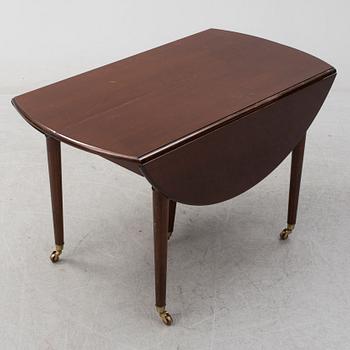 A mid 20th century mahogany veneered dining table by AB Harald Westerberg, Stockholm.