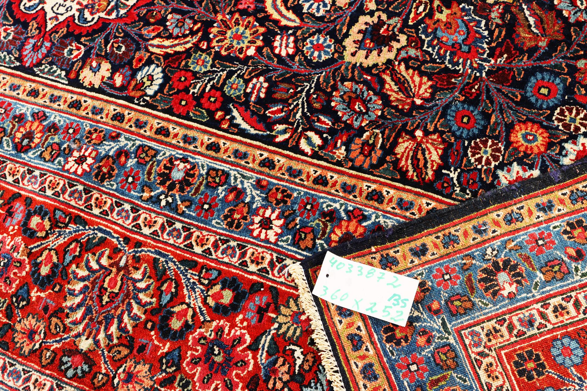 A semi-antique Meshad carpet, a. 360 x 252 cm.