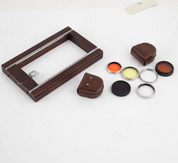 Two box cameras with accessories and a handheld stereo viewer.