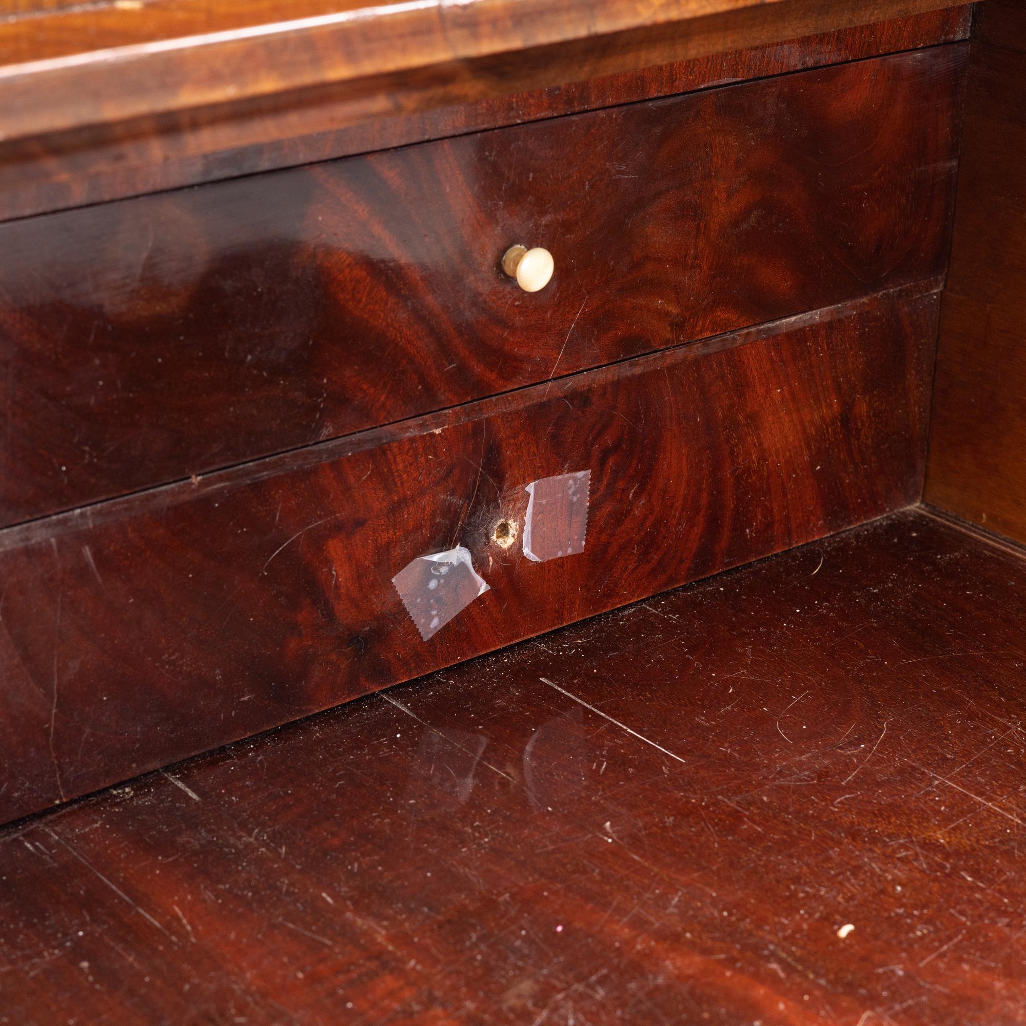 A mahogany veneered Empire chest of drawers, first half of the 20th Century.