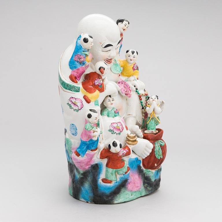A Chinese porcelain laughing buddha with children, the 20th century.