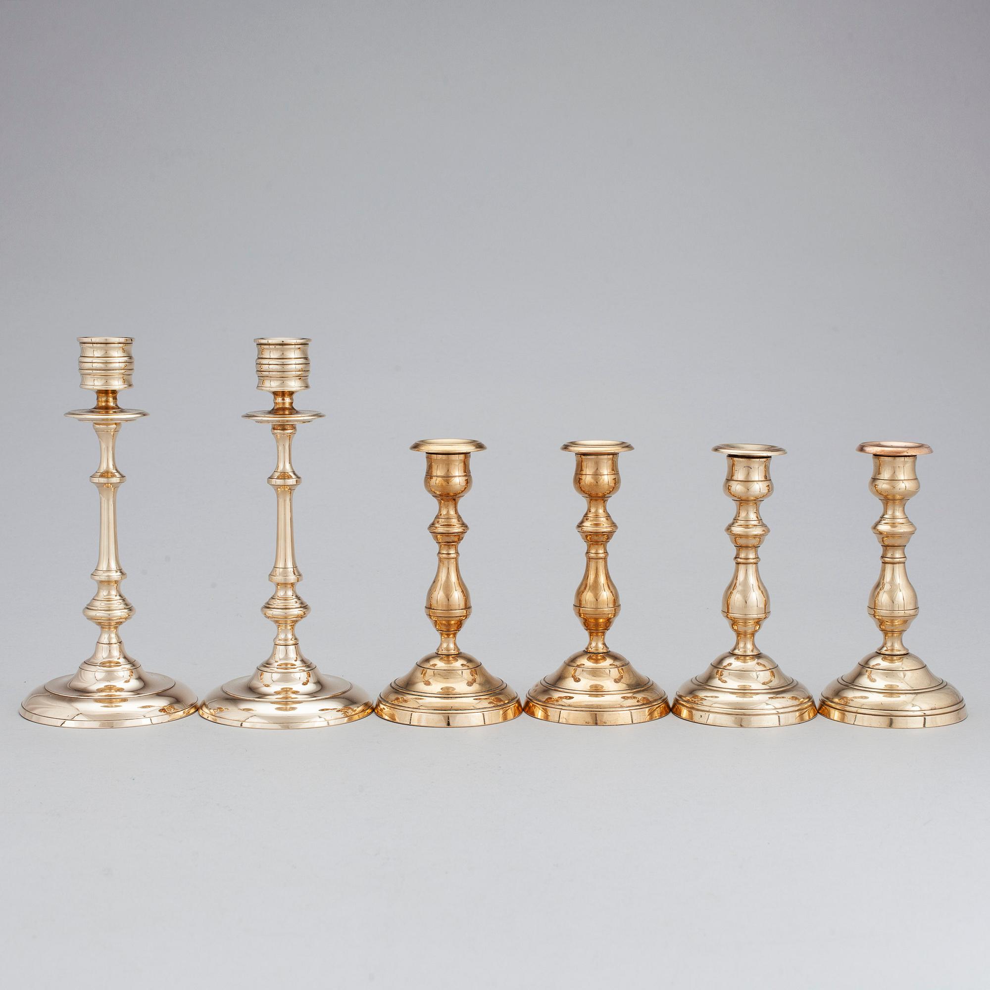 Three pair of candlesticks in brass, marked WMF, Westerås Metallfabrik and NLP. Late 19/early 20th century.