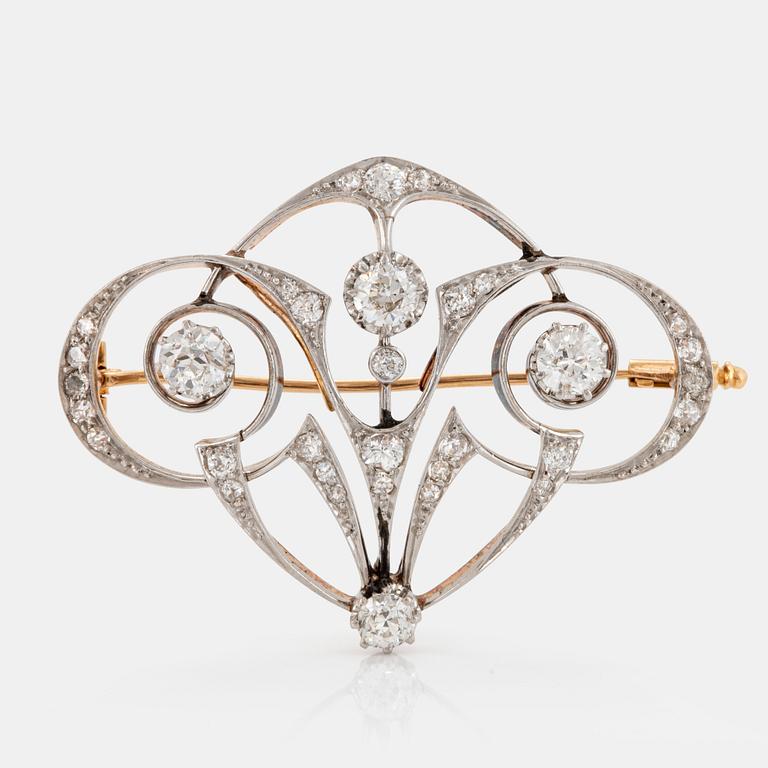 A platinum and 18K gold brooch set with old-cut diamonds.