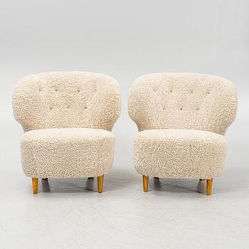 A pair of Scandinavian Modern 1940s cheepskin armchairs.