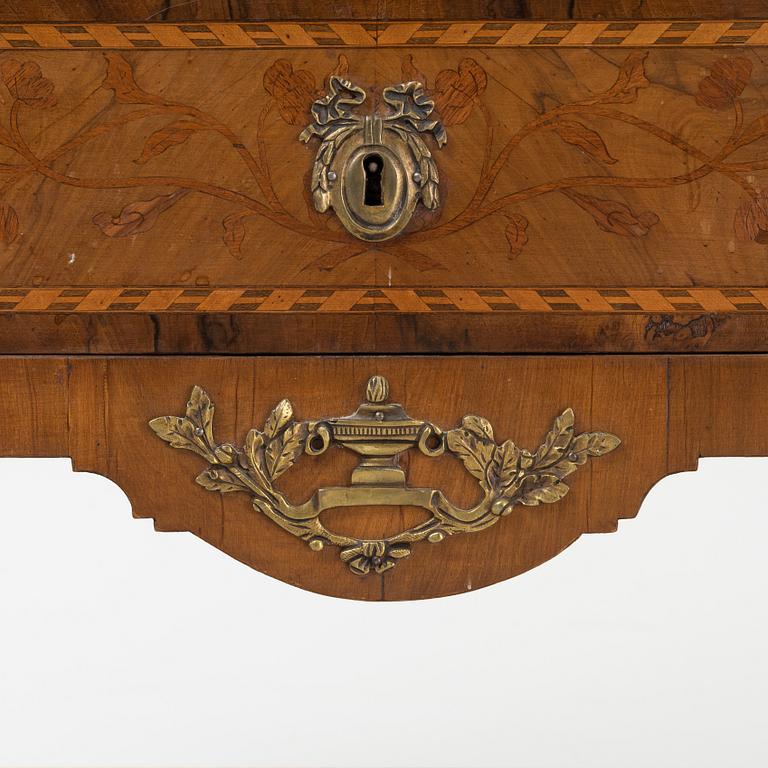 A Louis XVI-style marquetry and marble commode, later part of the 19th century.