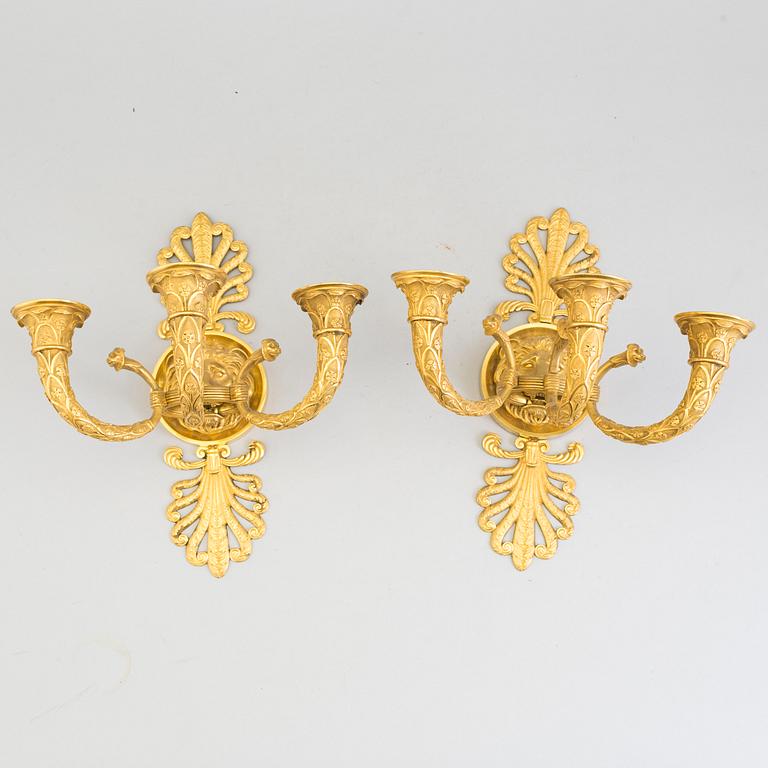 A pair of French Empire early 19th century three-light wall-lights.